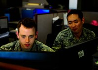 Airman Nick Roberts, a 1st Special Operations Comptroller Squadron accounting technician and Tech Sgt. Hiroshi Hatano, 1st SOCPTS NCO in-charge, inspects a financial account at Hurlburt Field, Fla., Dec. 4, 2014. The 1st SOCPTS financial professionals strive for continuous, courteous and accurate customer service. (U.S. Air Force photo/Senior Airman Christopher Callaway)