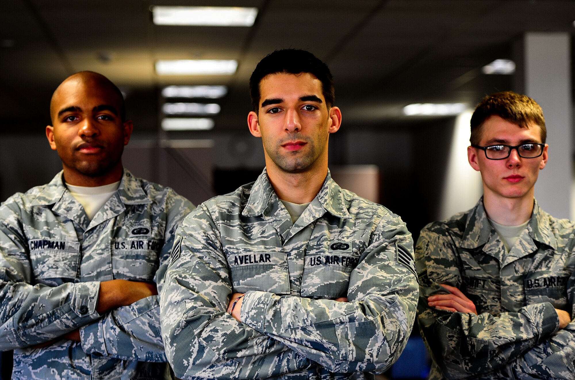 Staff Sgt. Eric Avellar (center), Senior Airman Jonathan Chapman (left) and Airman Mathew Swift, 1st Special Operations Comptroller Squadron, are part of a team that manages the financial business of Hurlburt Field, Fla.  The 1st SOCPTS financial professionals strive for continuous, courteous and accurate customer service. (U.S. Air Force photo/Senior Airman Christopher Callaway)