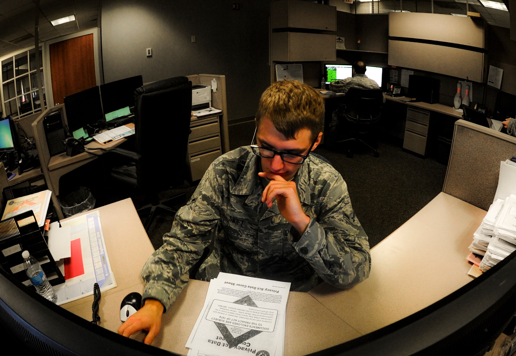Airman Mathew Swift, a 1st Special Operations lead defense travel administrator, prepares documents at Hurlburt Field, Fla., Dec. 4, 2014. The Finance office has two departments, one focused on budget and the other on customer service. (U.S. Air Force photo/Senior Airman Christopher Callaway) 