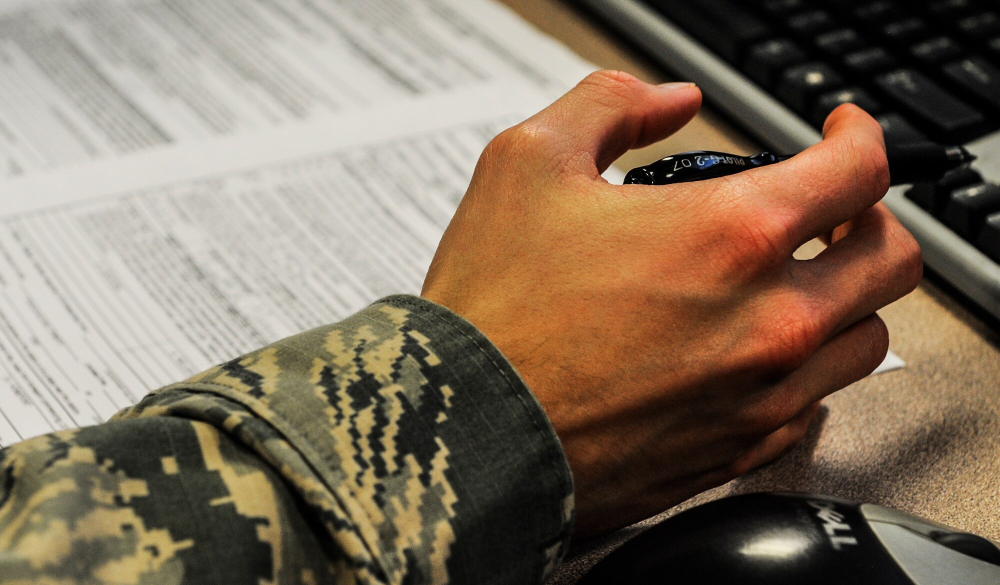 Airman Mathew Swift, a 1st Special Operations lead defense travel administrator, processes paperwork at Hurlburt Field, Fla., Dec. 4, 2014. The Finance office has two departments, one focused on budget and the other on customer service. (U.S. Air Force photo/Senior Airman Christopher Callaway) 