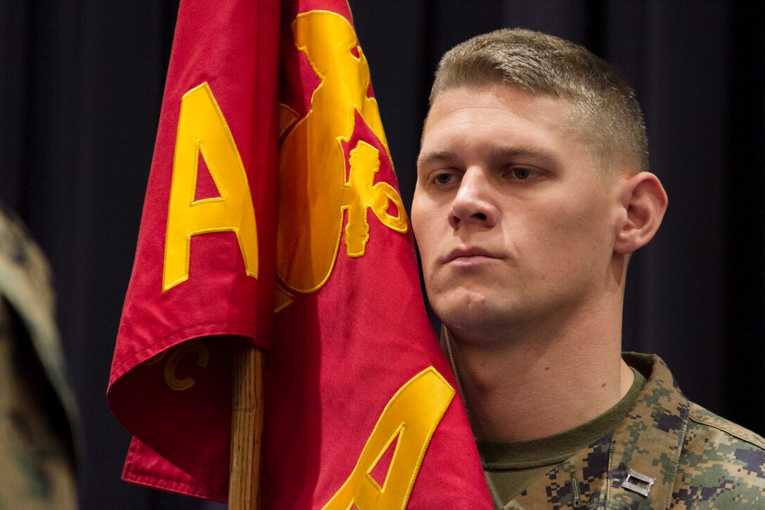 Capt. Tyler Tidwell stands at attention after receiving Company A’s guidon during a change of command ceremony for the company at Marine Barracks Washington, D.C., Dec. 8, 2014. During the ceremony, Capt. Tidwell relinquished command to Capt. Thomas Upchurch. Company A is one of two ceremonial marching units at the Barracks and is home to the United States Marine Corps Color Guard and the Silent Drill Platoon.