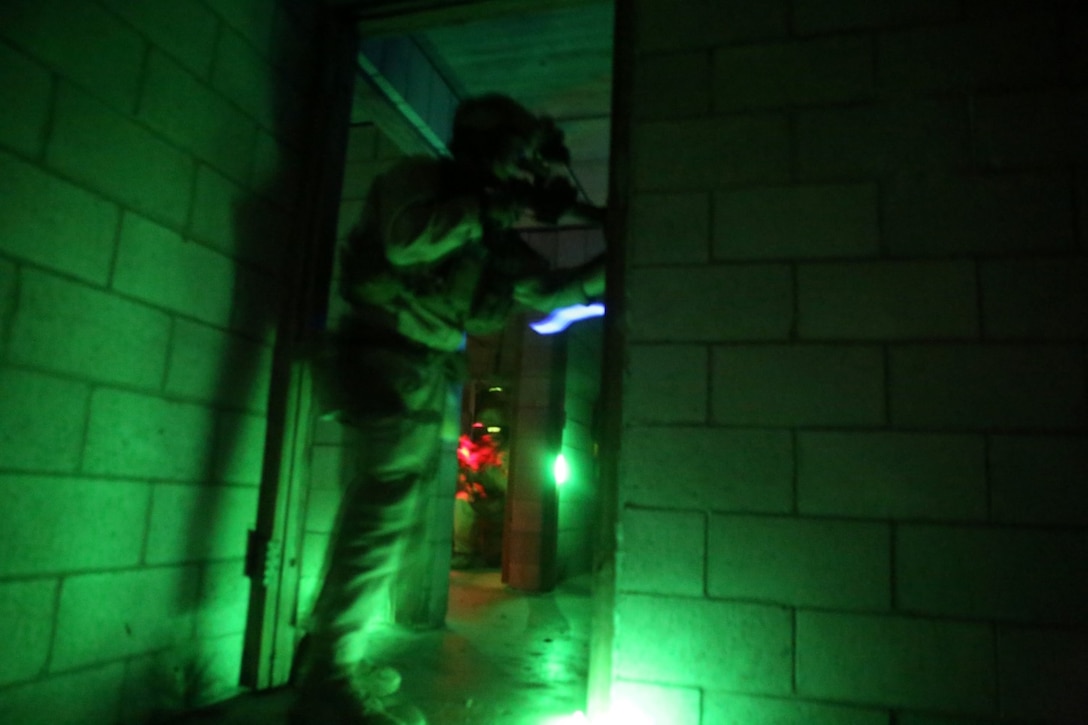 U.S. Marines with the 15th Marine Expeditionary Unit’s Maritime Raid Force conduct a raid during realistic urban training aboard Camp San Luis Obispo, Calif., Dec. 5, 2014. RUT prepares the Marines of the 15th MEU for their upcoming deployment, enhancing their combat skills in environments similar to those they may find in future missions. (U.S. Marine Corps photo by Cpl. Anna Albrecht/Released)