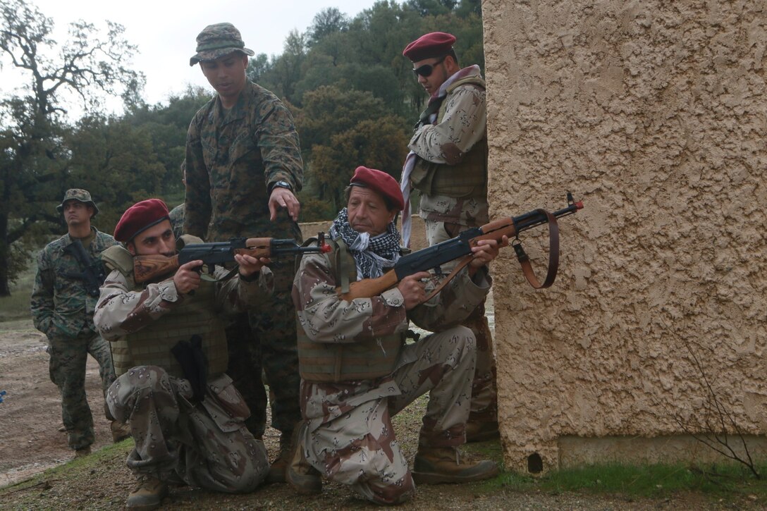 U.S. Marines conduct bilateral training during a Realistic Urban Training exercise aboard Fort Hunter Ligget, Calif., Dec. 6, 2014.  RUT prepares the 15th Marine Expeditionary Unit's Marines for their upcoming deployment, enhancing their combat skills in environments similar to those they may find in future missions. (U.S. Marine Corps Photo by Sgt. Jamean Berry/Released)