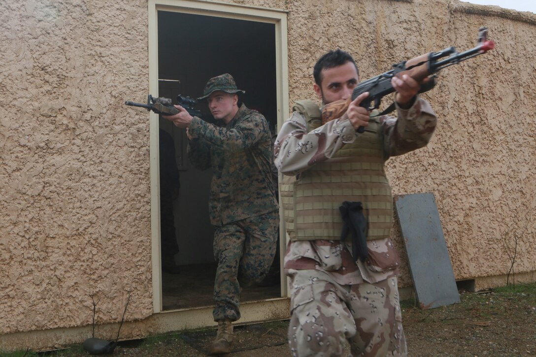 U.S. Marines conduct bilateral training during a Realistic Urban Training exercise aboard Fort Hunter Ligget, Calif., Dec. 6, 2014.  RUT prepares the 15th Marine Expeditionary Unit's Marines for their upcoming deployment, enhancing their combat skills in environments similar to those they may find in future missions. (U.S. Marine Corps Photo by Sgt. Jamean Berry/Released)