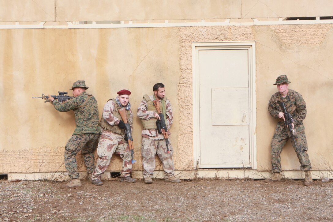 U.S. Marines conduct bilateral training during a Realistic Urban Training exercise aboard Fort Hunter Ligget, Calif., Dec. 6, 2014.  RUT prepares the 15th Marine Expeditionary Unit's Marines for their upcoming deployment, enhancing their combat skills in environments similar to those they may find in future missions. (U.S. Marine Corps Photo by Sgt. Jamean Berry/Released)