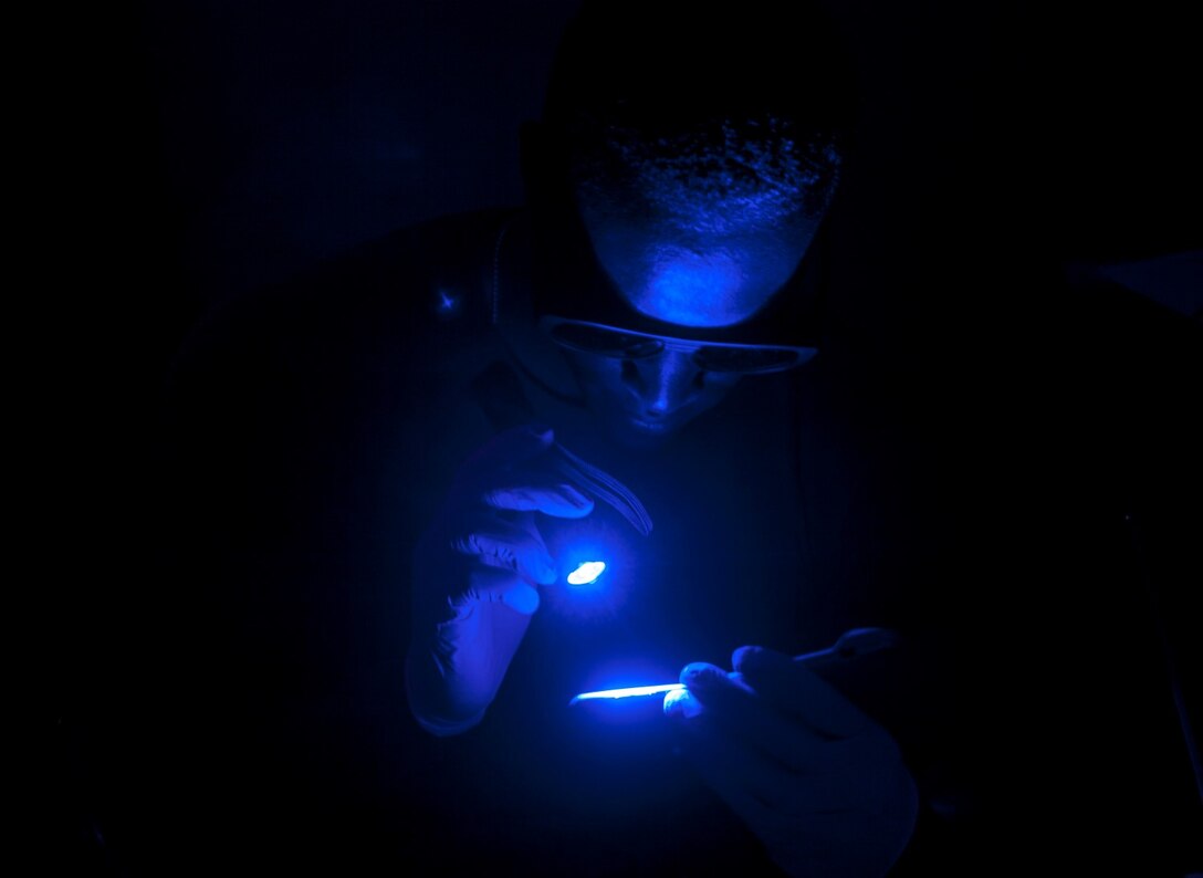 U.S. Marine Lance Cpl. Shaquille Tidwell looks at evidence for fingerprints during realistic urban training aboard Fort Hunter Liggett, Calif., Dec. 6, 2014. Tidwell is a military policeman with the Law Enforcement Detachment, Combat Logistics Battalion 15, 15th Marine Expeditionary Unit. RUT prepares the 15th MEU Marines for their upcoming deployment, enhancing their combat skills in environments similar to those they may find in future missions. (U.S. Marine Corps photo by Cpl. Elize McKelvey/Released)