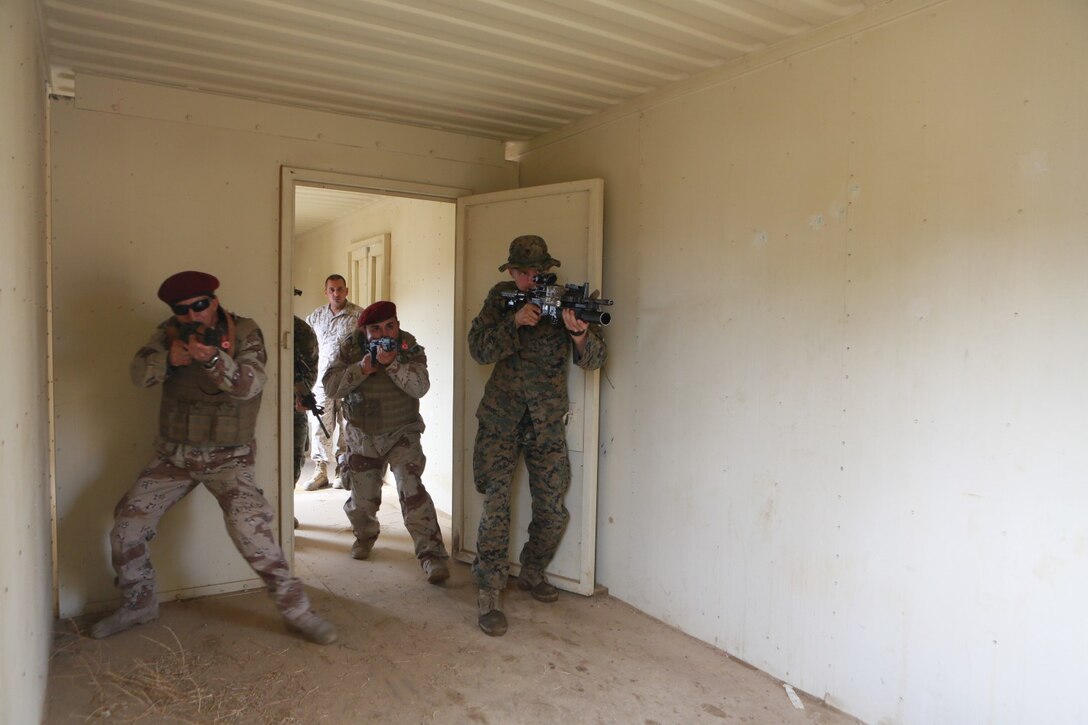 U.S. Marines conduct simulated bilateral training during a Realistic Urban Training exercise aboard Fort Hunter Ligget, Calif., Dec. 6, 2014.  RUT prepares the 15th Marine Expeditionary Unit's Marines for their upcoming deployment, enhancing their combat skills in environments similar to those they may find in future missions. (U.S. Marine Corps Photo by Sgt. Jamean Berry/Released)