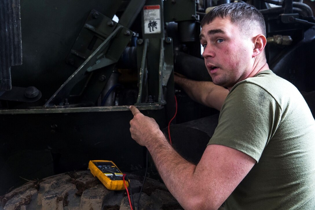 U.S. Marine Sgt. Harley Inscore tests a Medium Tactical Vehicle Replacement’s batteries during realistic urban training aboard Fort Hunter Liggett, Calif., Dec. 6, 2014. Inscore is a motor transportation mechanic with Combat Logistics Battalion 15, 15th Marine Expeditionary Unit. The purpose of RUT is to provide the MEU an opportunity to conduct training in unfamiliar environments in preparation for their upcoming deployment. (U.S. Marine Corps photo by Cpl. Anna Albrecht/Released)