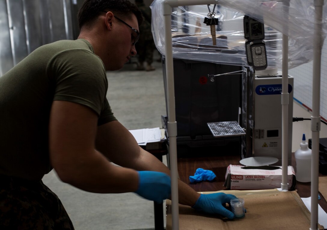 U.S. Marine Lance Cpl. Branden Hays fumigates evidence for fingerprints during realistic urban training aboard Fort Hunter Liggett, Calif., Dec. 6, 2014. Hays is a military policeman with the Law Enforcement Detachment, Combat Logistics Battalion 15, 15th Marine Expeditionary Unit. RUT prepares the 15th MEU’s Marines for their upcoming deployment, enhancing their combat skills in environments similar to those they may find in future missions. (U.S. Marine Corps photo by Cpl. Elize McKelvey/Released)