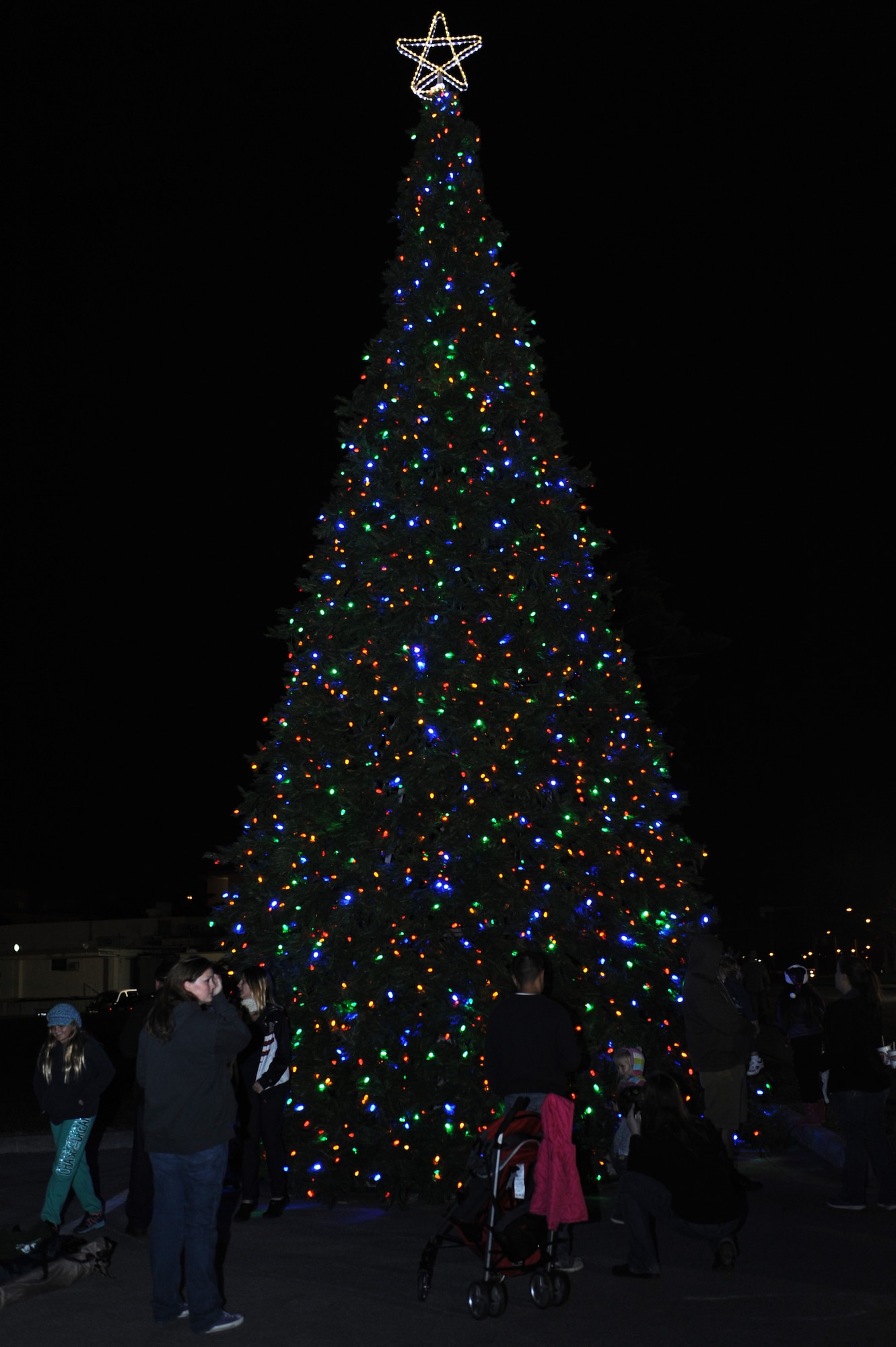 Kadena's Christmas tree is illuminated during the tree-lighting ceremony on Kadena Air Base, Japan, Dec. 6, 2014. Tinsel Town is Kadena's annual holiday celebration offering meet-and-greets with Santa and Mrs. Claus, games, food and free entertainment. (U.S. Air Force photo by Airman 1st Class Zade C. Vadnais/Released)