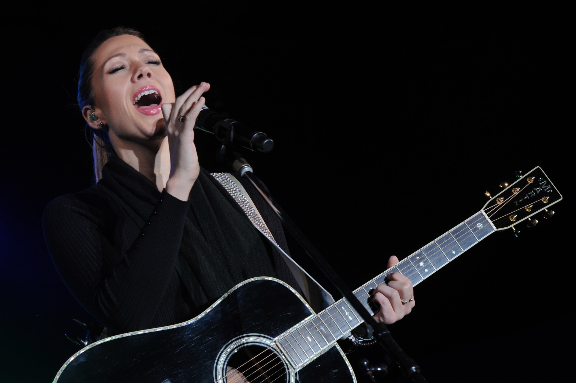American singer-songwriter Colbie Caillat performs at the Tinsel Town event on Kadena Air Base, Japan, Dec. 6, 2014. Caillat, the event's special guest, performed several songs at the event, which also included performances from the Capitol Movement Dance Company and a meet-and-greet with Santa and Mrs. Claus. (U.S. Air Force photo by Airman 1st Class Zade C. Vadnais/Released)
