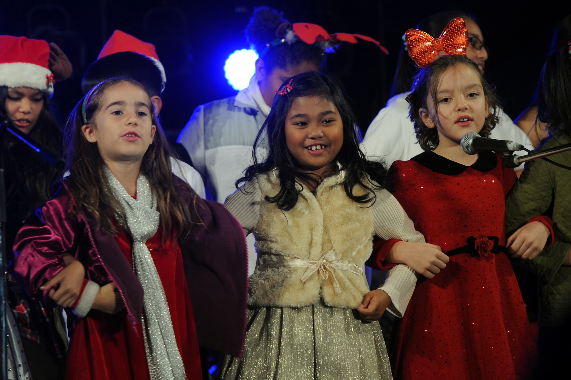Members of the Kadena Chapel Children's Christmas Choir sing holiday songs at the Tinsel Town event on Kadena Air Base, Japan, Dec. 6, 2014. Special guest Colbie Caillat, an American singer-songwriter, performed several songs at the event, which also included performances from the Capitol Movement Dance Company and a meet-and-greet with Santa and Mrs. Claus. (U.S. Air Force photo by Airman 1st Class Zade C. Vadnais/Released)