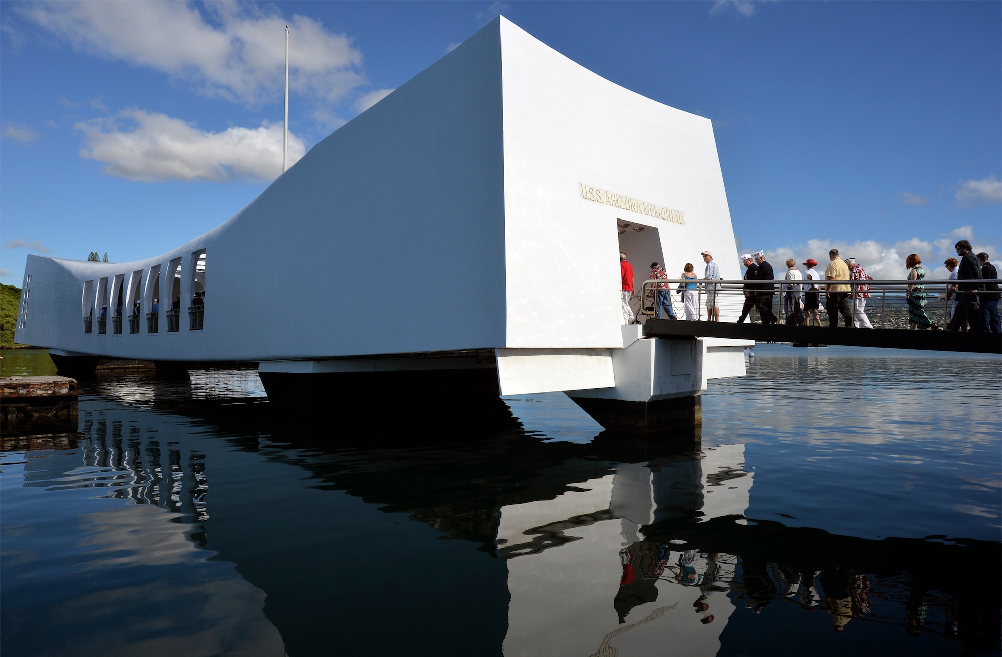 Vistors enter the USS Arizona Memorial during the 73rd anniversary Pearl Harbor Day commemoration ceremony at the Pearl Harbor Visitor Center. More than 2,000 guests, including Pearl Harbor survivors and other veterans, attended the National Park Service and U.S. Navy hosted joint memorial ceremony at the World War II Valor in the Pacific National Monument. This year's theme focused on "Preserving the Memory." (U.S. Navy photo by Mass Communication Specialist 2nd Class Laurie Dexter/Released)