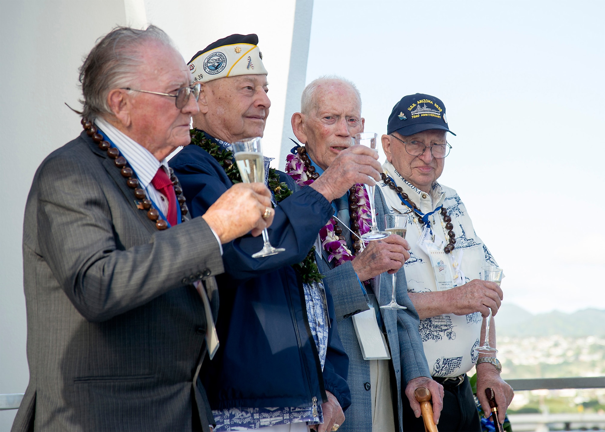 Four of the nine remaining USS Arizona survivors, Donald Stratton, left, Louis Conter, John Anderson, and Lauren Bruner, toast in honor of fallen shipmates and service members of the Dec. 7, 1941 Japanese attack on Pearl Harbor aboard the USS Arizona Memorial at Joint Base Pearl Harbor-Hickam. The four Pearl Harbor survivors announced this year's USS Arizona Reunion Association ceremony to be the final of its kind. The final toast symbolizes the brotherhood and sacrifice of the day of the attack on Pearl Harbor 73 years ago. More than 2,500 guests, including Pearl Harbor survivors and other veterans, attended the National Park Service and U.S. Navy-hosted joint memorial ceremony at the World War II Valor in the Pacific National Monument. (U.S. Navy Photo by Mass Communication Specialist 2nd Class Johans Chavarro/Released)