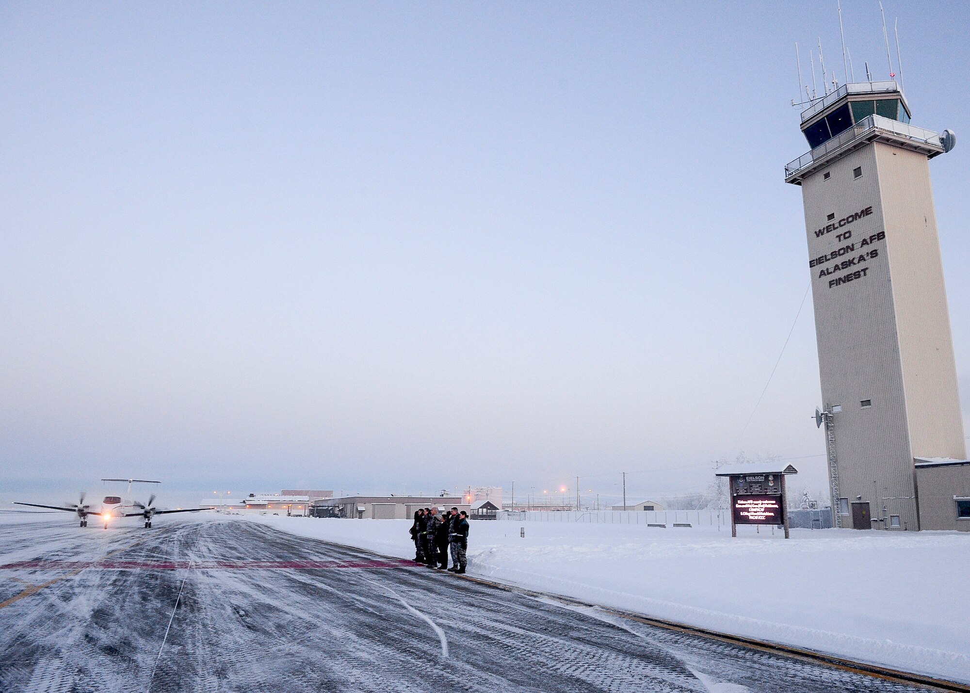 The 354th Fighter Wing leadership and their spouses stand outside to greet U.S. Air Force Gen. Lori Robinson, the Pacific Air Forces commander, upon her arrival at Eielson Air Force Base, Alaska, Dec. 4, 2014. During her visit to Eielson, Gen. Robinson visited Airmen and families and witnessed Eielson missions and operations with Chief Master Sgt. Buddy Hutchison, the PACAF command chief.  (U.S. Air Force photo by Staff Sgt. Shawn Nickel/Released)
