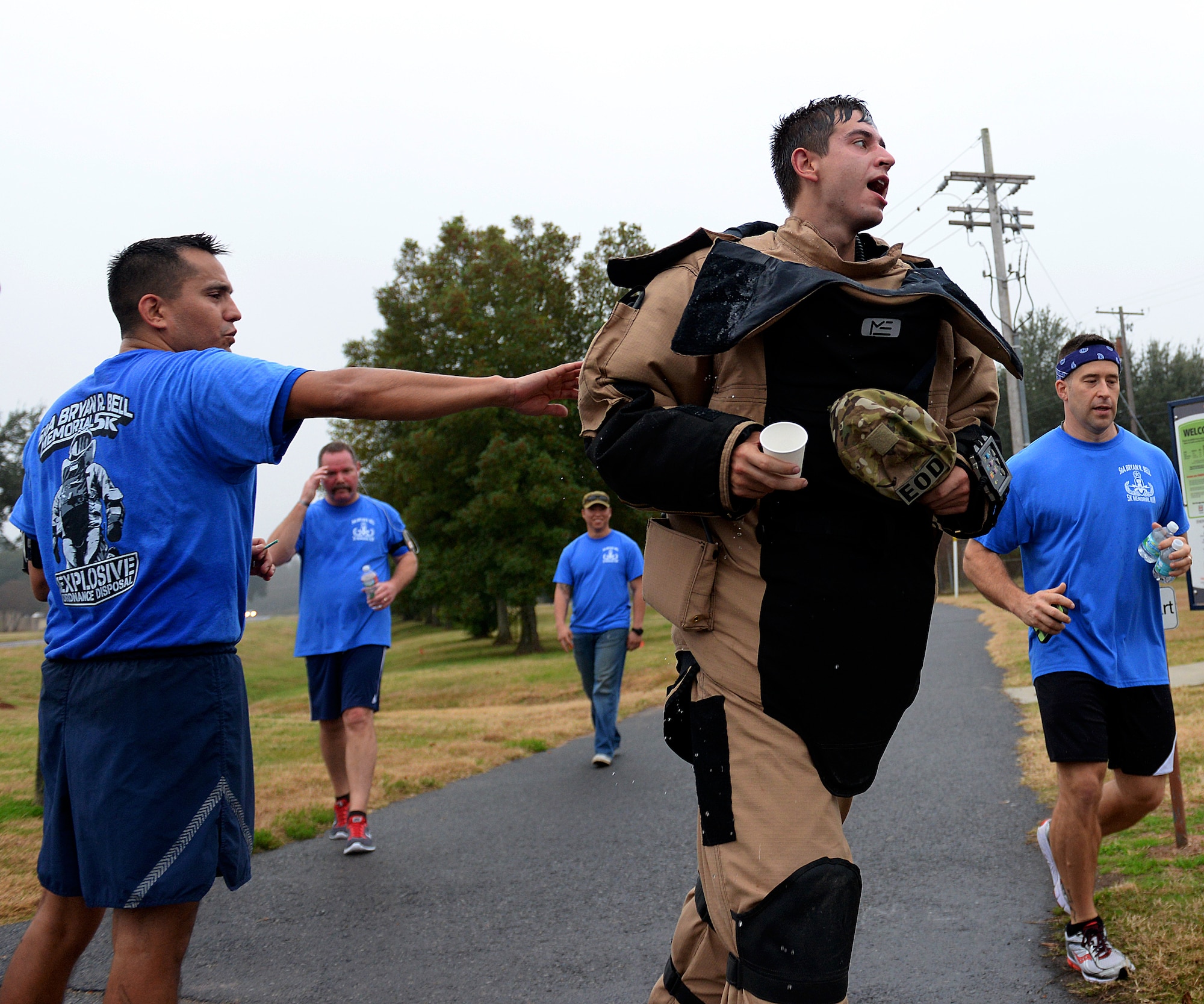 Team Barksdale supports Airman 1st Class Alex Keskinen, 2nd Civil Engineer Squadron Explosive Ordnance Disposal technician, as he prepares to enter the final leg of the first SrA Bryan R. Bell 5K Memorial Run on Barksdale Air Force Base, La., Dec. 5, 2014. The run honored Bell, who gave his life defending his country in Afghanistan in 2012 in support of Operation Enduring Freedom. (U.S. Air Force photo/Airman 1st Class Curt Beach)