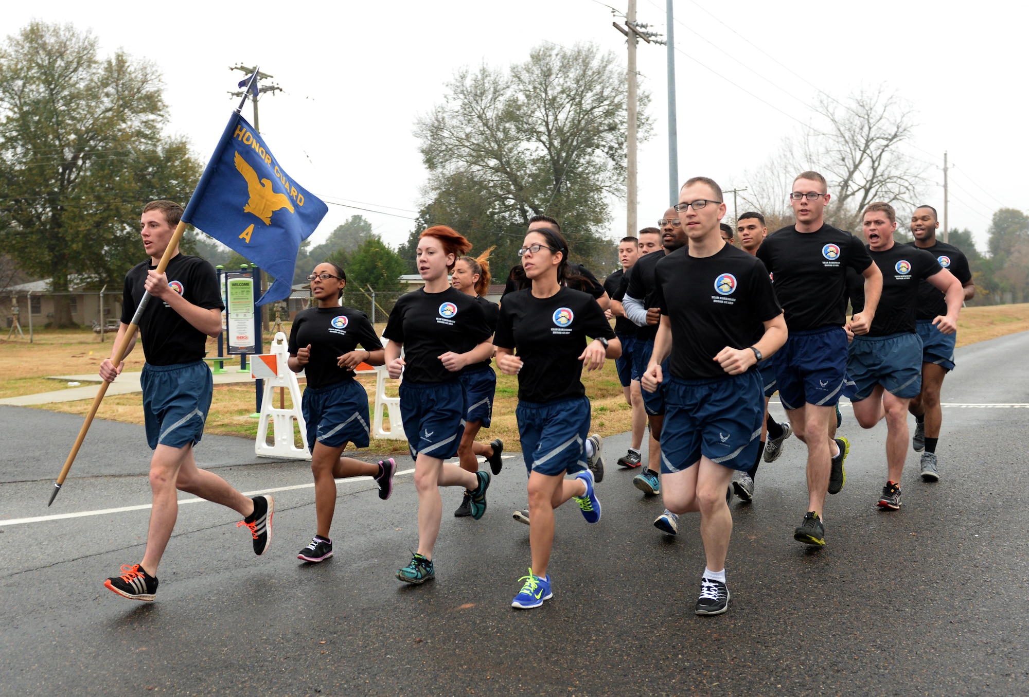 Barksdale Honor Guard members run in formation in the first SrA Bryan R. Bell 5K Memorial Run on Barksdale Air Force Base, La., Dec. 5, 2014. The run honored Bell, who gave his life defending his country in Afghanistan in 2012 in support of Operation Enduring Freedom. (U.S. Air Force photo/Airman 1st Class Curt Beach)