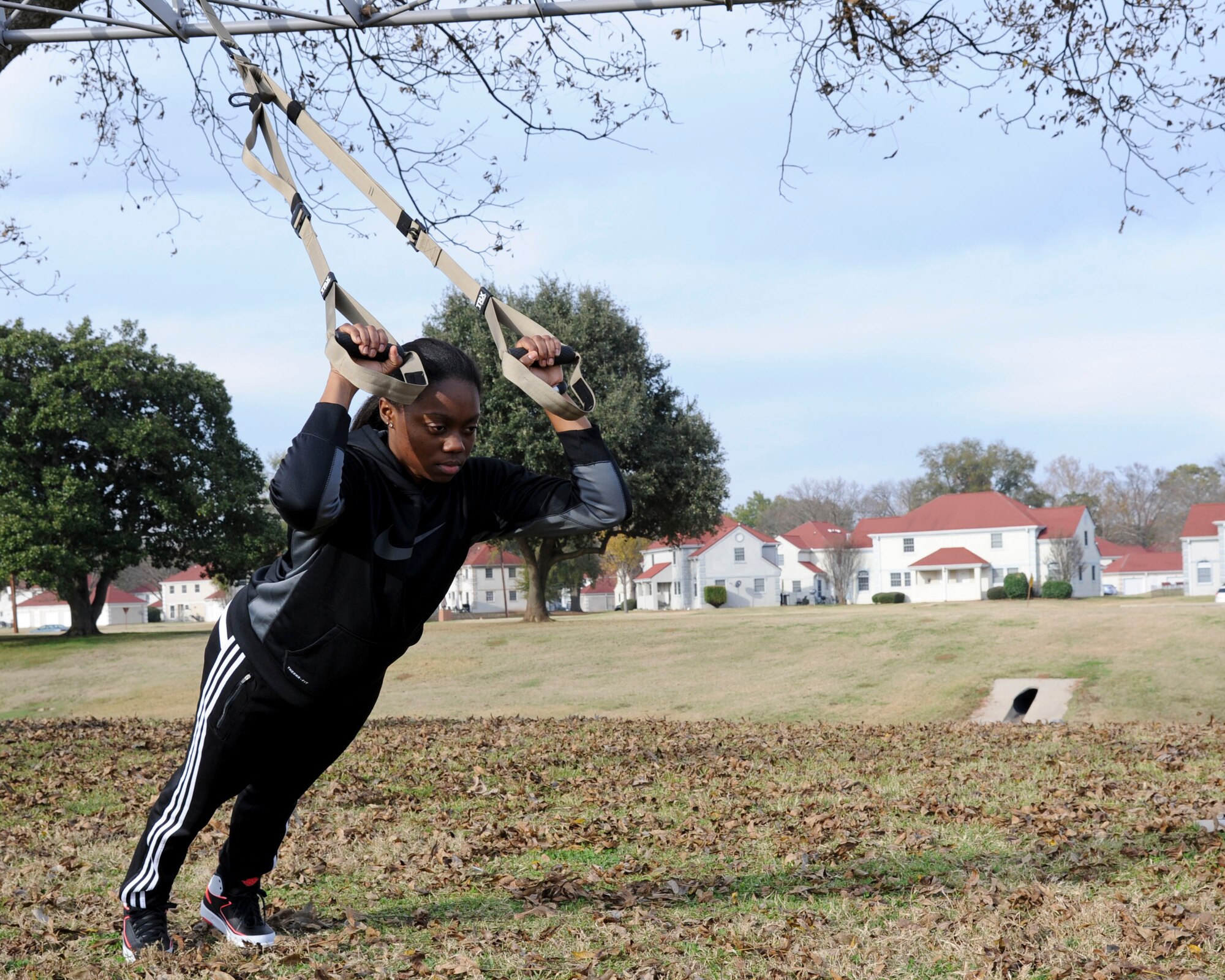 Senior Airman Ashley Thompson, 2nd Communications Squadron network operations technician, demonstrates the triceps extension exercise from a new resistance training program on Barksdale Air Force Base, La., Dec. 7, 2014. The Barksdale Fitness Center has added 18 group aerobic exercise classes along with the new program to stay current with the latest workouts. (U.S. Air Force photo/ Senior Airman Jannelle Dickey)