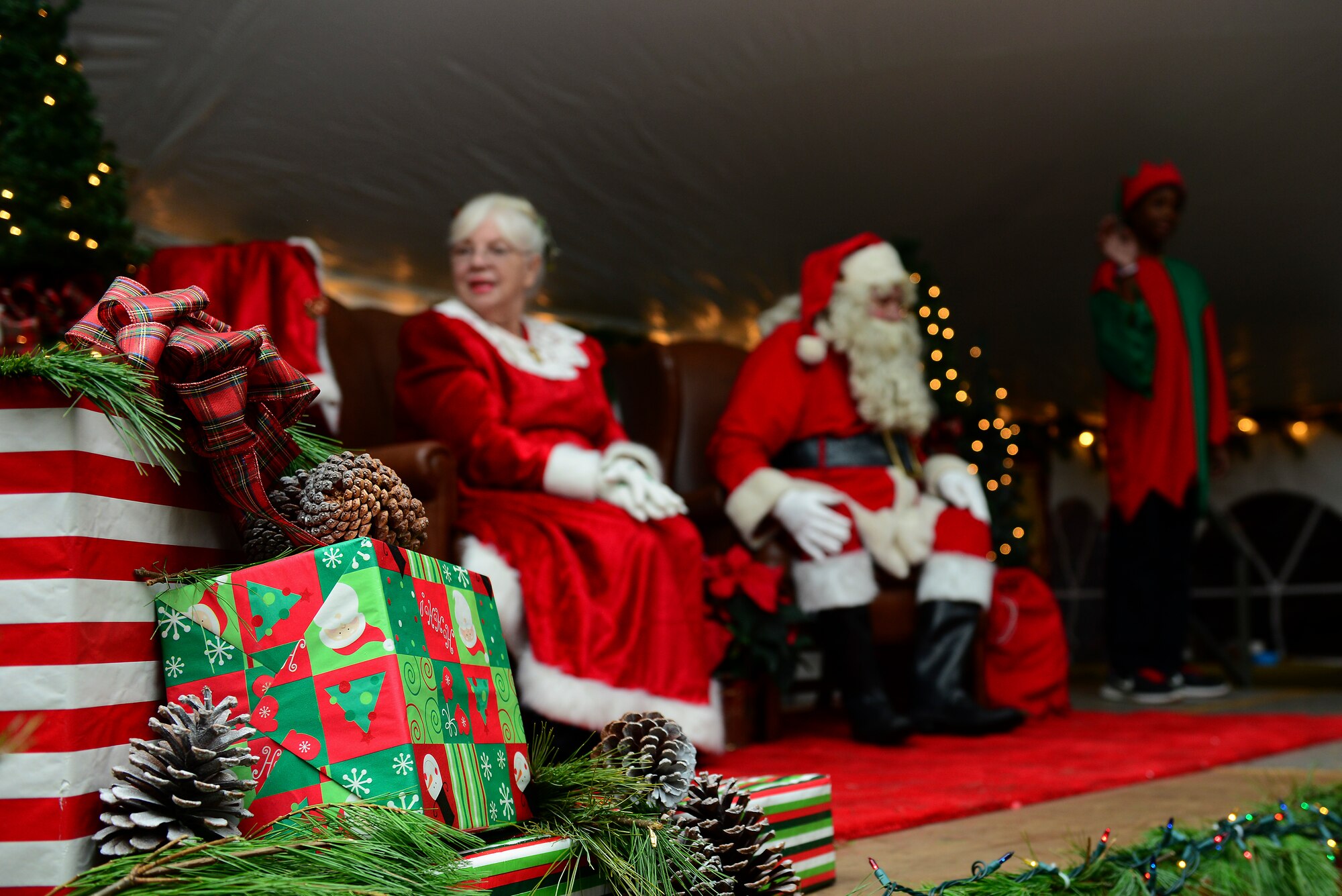 Santa and Mrs. Claus spoke with kids after the 59th Annual Christmas Tree lighting at Fort Eustis, Va., Dec. 5, 2014. Santa and Mrs. Claus surprised the crowd by arriving on one of the Fort Eustis Fire Department's fire trucks. (U.S. Air Force photo by Senior Airman Kimberly Nagle/Released)