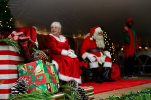 Santa and Mrs. Claus spoke with kids after the 59th Annual Christmas Tree lighting at Fort Eustis, Va., Dec. 5, 2014. Santa and Mrs. Claus surprised the crowd by arriving on one of the Fort Eustis Fire Department's fire trucks. (U.S. Air Force photo by Senior Airman Kimberly Nagle/Released)