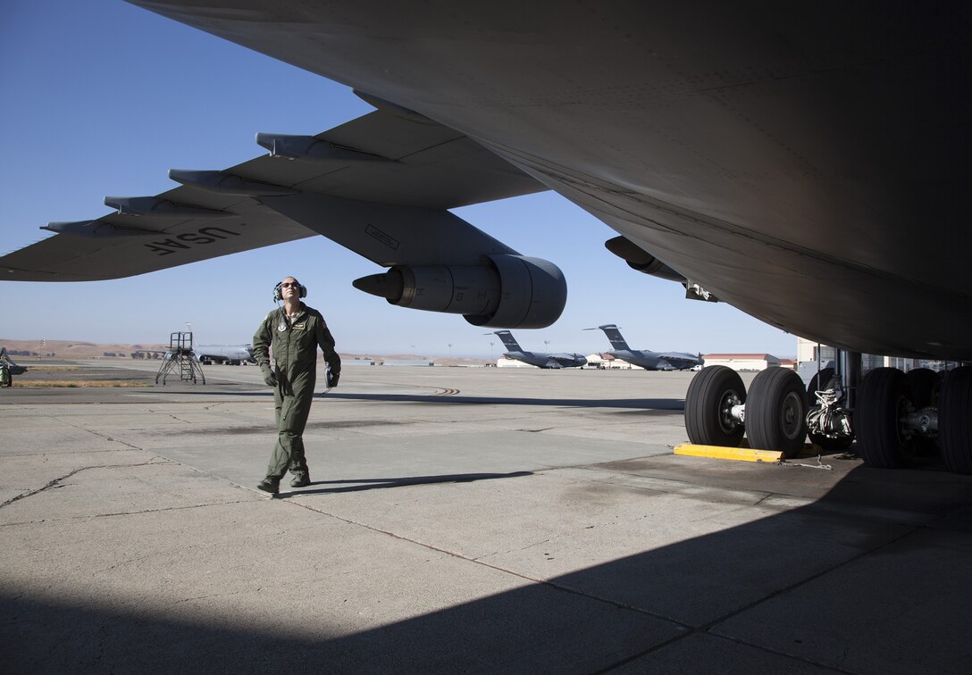 TRAVIS AIR FORCE BASE, Calif. --Tech. Sgt. Francisco Guerrero-Vasquez, flight engineer with the 312th Airlift Squadron, performs a pre-flight "walk around" inspection of a C-5B Galaxy Aug. 11, 2014, at Travis Air Force Base, Calif. The C-5 Galaxy is a heavy airlifter with intercontinental range. It is the largest U.S. military aircraft, capable of carrying more than 270,000 pounds of cargo. (U.S. Air Force photo/Lt. Col. Robert Couse-Baker)