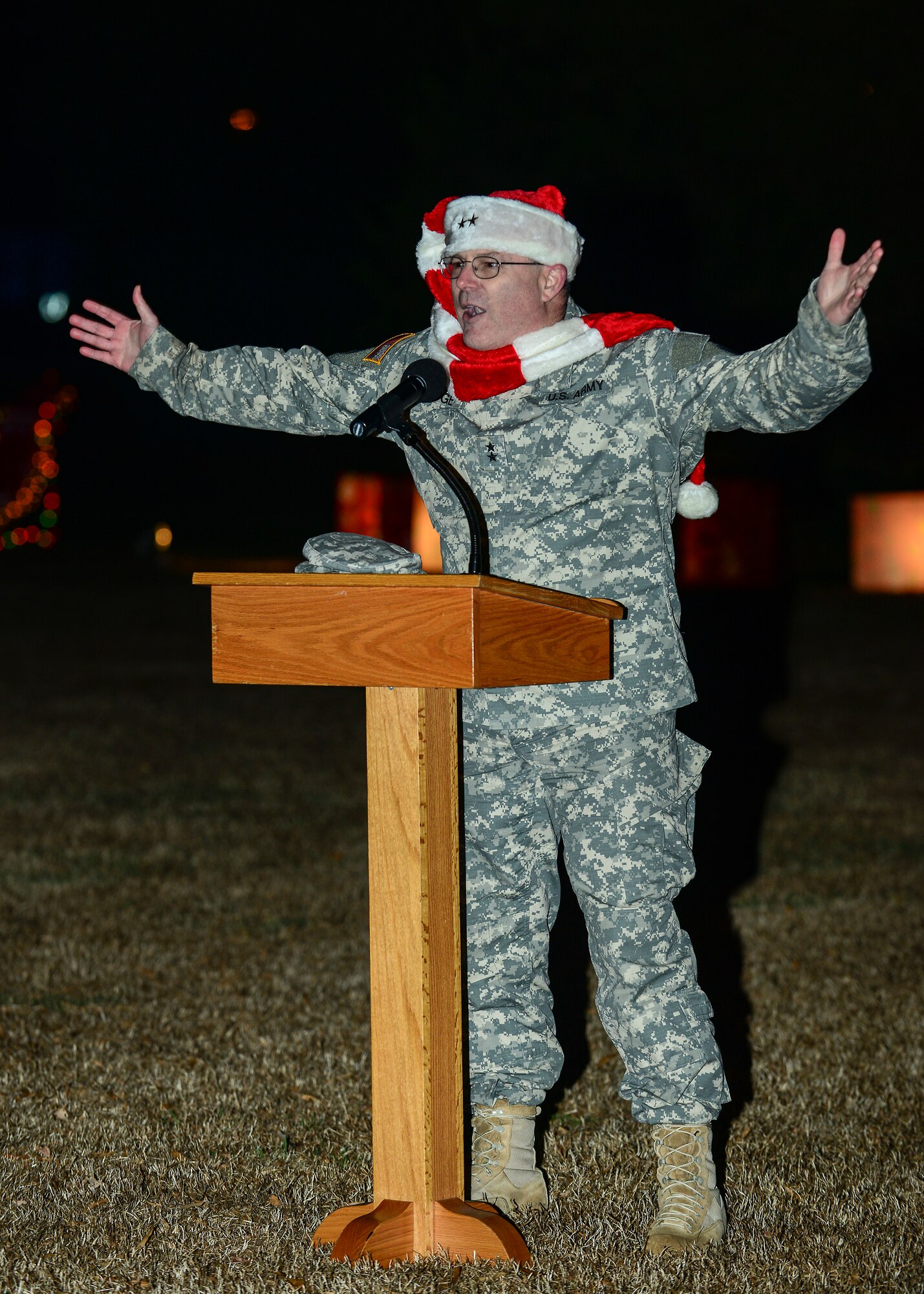 U.S. Army Maj. Gen. Ross Ridge, U.S. Army Initial Military Training Center of Excellence deputy commanding general, gets the crowd in the holiday spirit during the 59th annual Christmas tree lighting at Fort Eustis, Va., Dec. 5, 2014. During the tree lighting, members of the U.S. Army Training and Doctrine Command Band as well as the children of the chapels religious education program, children of Awana and Woodside High Schools Select Women’s Ensemble performed. (U.S. Air Force photo by Senior Airman Kimberly Nagle/Released) 