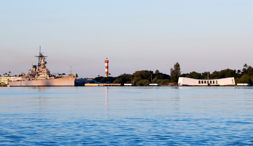 The sun rises over the Battleship Missouri and USS Arizona Memorials on the 73rd Anniversary Pearl Harbor Day at Pearl Harbor, Hawaii, Dec. 7, 2014. More than 2,000 guests, including Pearl Harbor survivors and other veterans, attended the National Park Service and U.S. Navy-hosted joint memorial ceremony at the World War II Valor in the Pacific National Monument. This year's theme focused on "Preserving the Memory." (U.S. Navy photo by Mass Communication Specialist 2nd Class Diana Quinlan/Released)