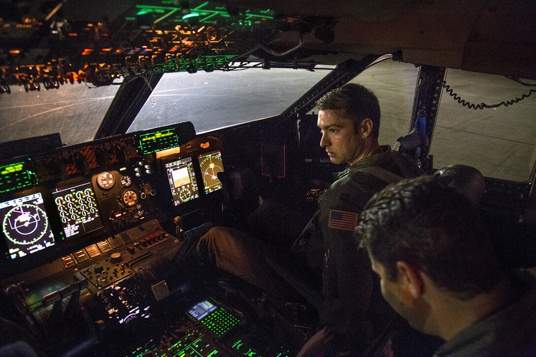 TRAVIS AIR FORCE BASE, Calif. --Capt. Jordan Kalish (top), instructor pilot; and Maj. Nick Amenta (right), aircraft commander; prepare a C-5B Galaxy for takeoff Aug. 15, 2014 from Kadena Air Base, Japan. The aviators from the 312th Airlift Squadron, Travis Air Force Base, Calif., were flying a mobility channel mission, moving high-priority cargo and passengers among air bases in the U.S. Pacific Command area of responsibility.  (U.S. Air Force photo/Lt. Col. Robert Couse-Baker)