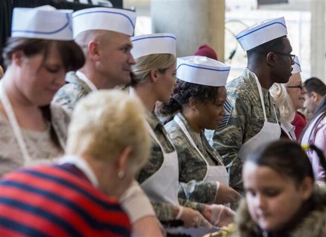 The Utah Jazz and Hill AFB military service members serve around 4,000 people lunch at the Energy Solutions Arena as part of their 16th annual "We Care-We Share" program for homeless and low-income residents. 