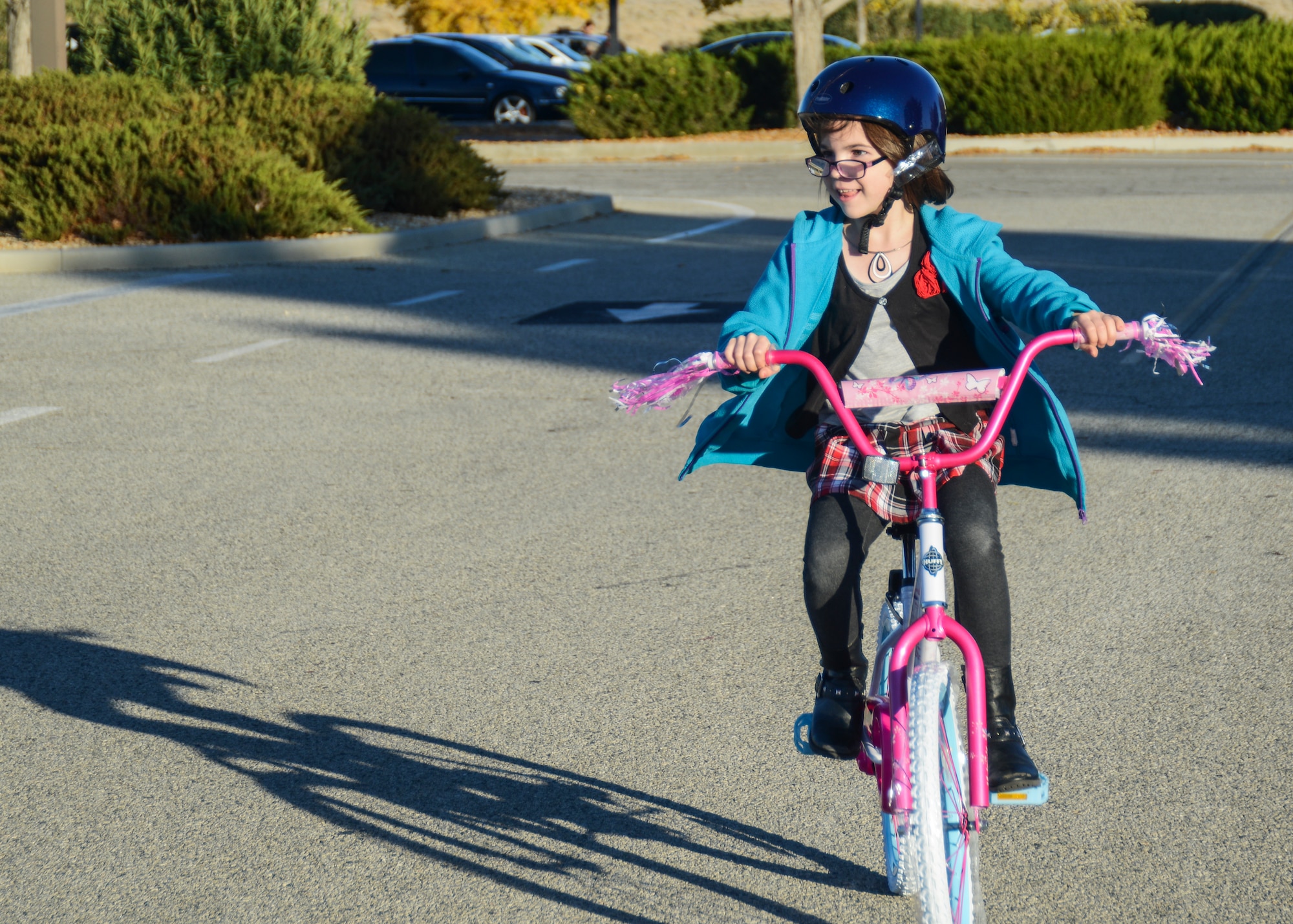 Emily Christie received a brand new bicycle from Northrop Grumman Dec. 4. She proudly rode her bike around the Base Exchange parking lot immediately after receiving it. (U.S. Air Force photo by Rebecca Amber) 