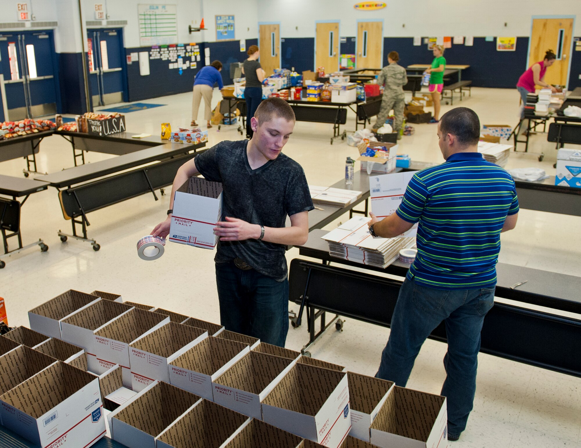The Company Grade Officer’s Council and volunteers set up stations for the numerous items that were donated for care packages at the Eglin Elementary School cafeteria during the troop care drive Dec. 5. The CGOC collected 2,500 cards, letters and drawings from local schools and the Red Cross. These cards, letters and drawings were included in the care packages along with books, coffee, magazines, snacks and various comfort items. The items were donated by various community businesses and organizations, and the CGOC, who also hosted the event. Volunteers packed a total of 92 care packages for Eglin’s deployed. (U.S. Air Force photo/Ilka Cole)