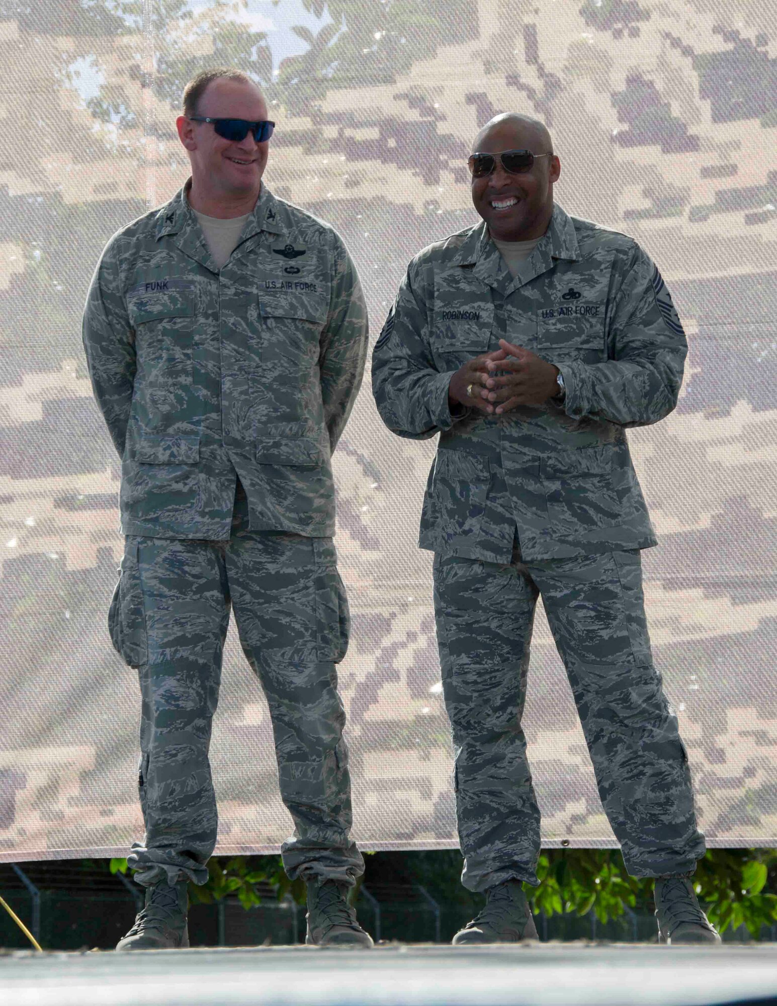 Col. Chris Funk, 482nd Fighter Wing commander, and Command Chief Master Sgt. Robinson, 482nd FW command chief, laugh while Funk’s high school football Coach Gary Weller reminisces about him as a teenager during a commander's call at Homestead Air Reserve Base, Fla., Dec. 6. (U.S. Air Force photo by Senior Airman Jaimi L. Upthegrove)