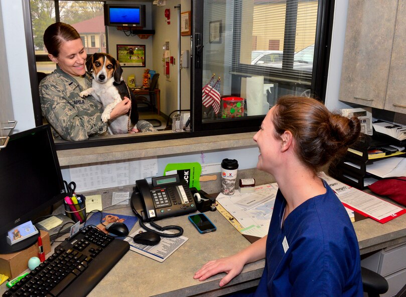Liz Duncan, 2nd Medical Group animal health technician, checks in Abby, a beagle, for her veterinarian exam on Barksdale Air Force Base, La.,  Dec. 3, 2014. The veterinary clinic offers a variety of services such as vaccinations, blood work, and medication prescriptions for many types of animals. The clinic's primary mission is caring for the military working dogs. (U.S Air Force photo/Airman 1st Class Mozer O. Da Cunha)
