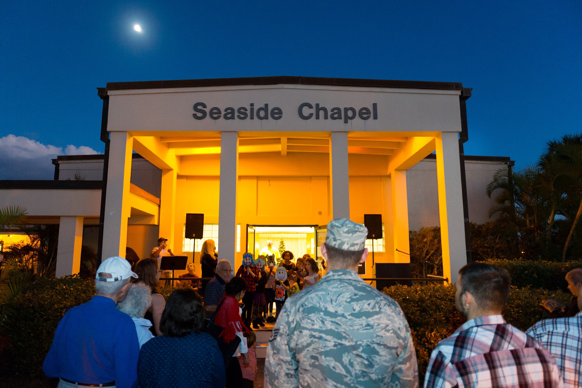 Members of Team Patrick-Cape attended a tree lighting ceremony at the Patrick Air Force Base Seaside Chapel, Dec. 3, 2014, in Fla. In addition to the lighting ceremony, attendees sang carols, ate refreshments, and socialized. (U.S. Air Force photo/Cory Long)