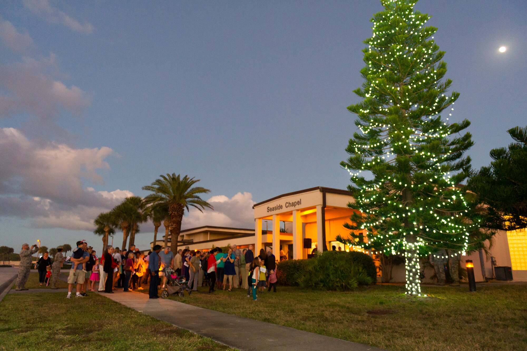 Members of Team Patrick-Cape attended a tree lighting ceremony at the Patrick Air Force Base Seaside Chapel, Dec. 3, 2014, in Fla. In addition to the lighting ceremony, attendees sang carols, ate refreshments, and socialized. (U.S. Air Force photo/Cory Long)