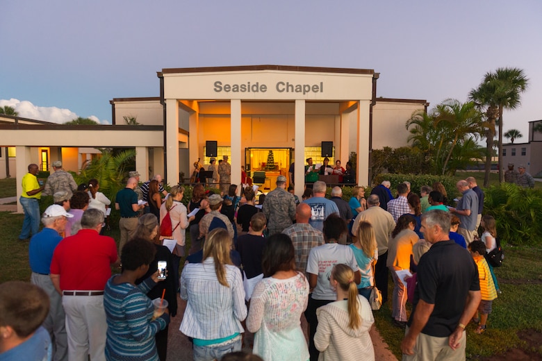 Members of Team Patrick-Cape attended a tree lighting ceremony at the Patrick Air Force Base Seaside Chapel, Dec. 3, 2014, in Fla. In addition to the lighting ceremony, attendees sang carols, ate refreshments, and socialized. (U.S. Air Force photo/Cory Long)