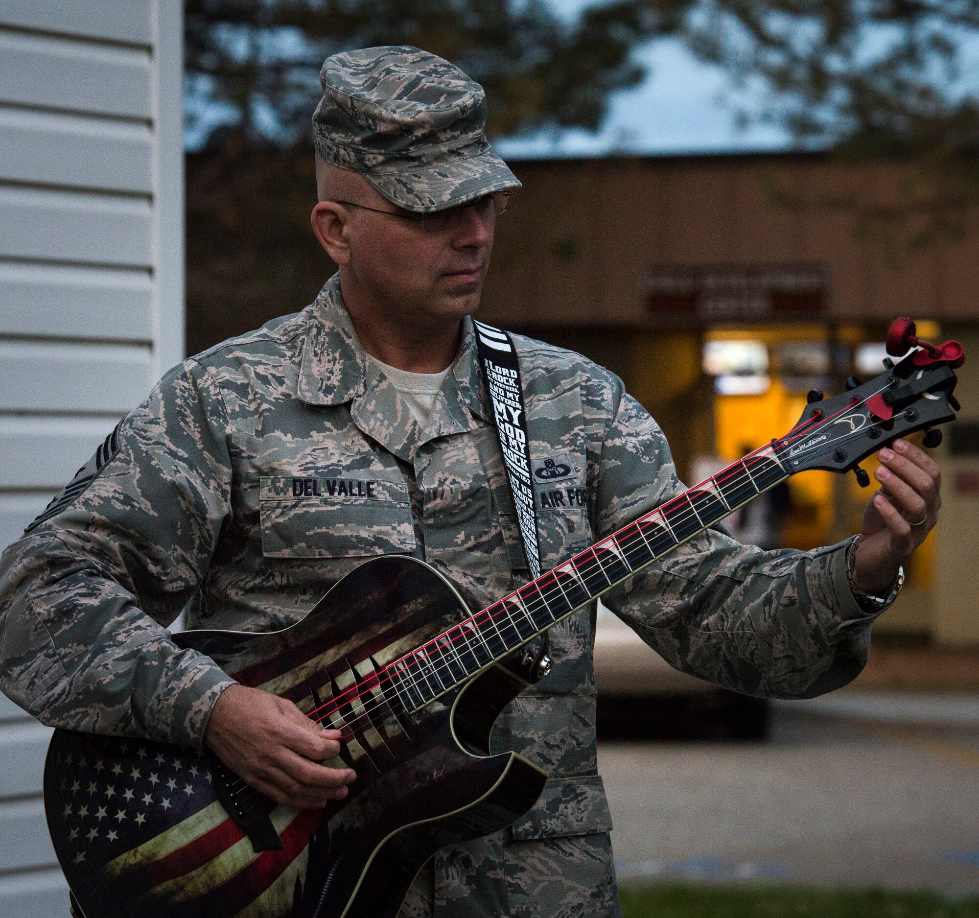 Chief Master Sgt. Alex del Valle, 366th Fighter Wing command chief, plays the guitar and sings Christmas carols at Mountain Home Air Force Base, Idaho Dec. 5, 2014. Del Valle was joined by his wife and son to sing "Silent Night" and "Joy to the World." (U.S. Air Force photo by Airman 1st Class Jessica Smith/RELEASED)