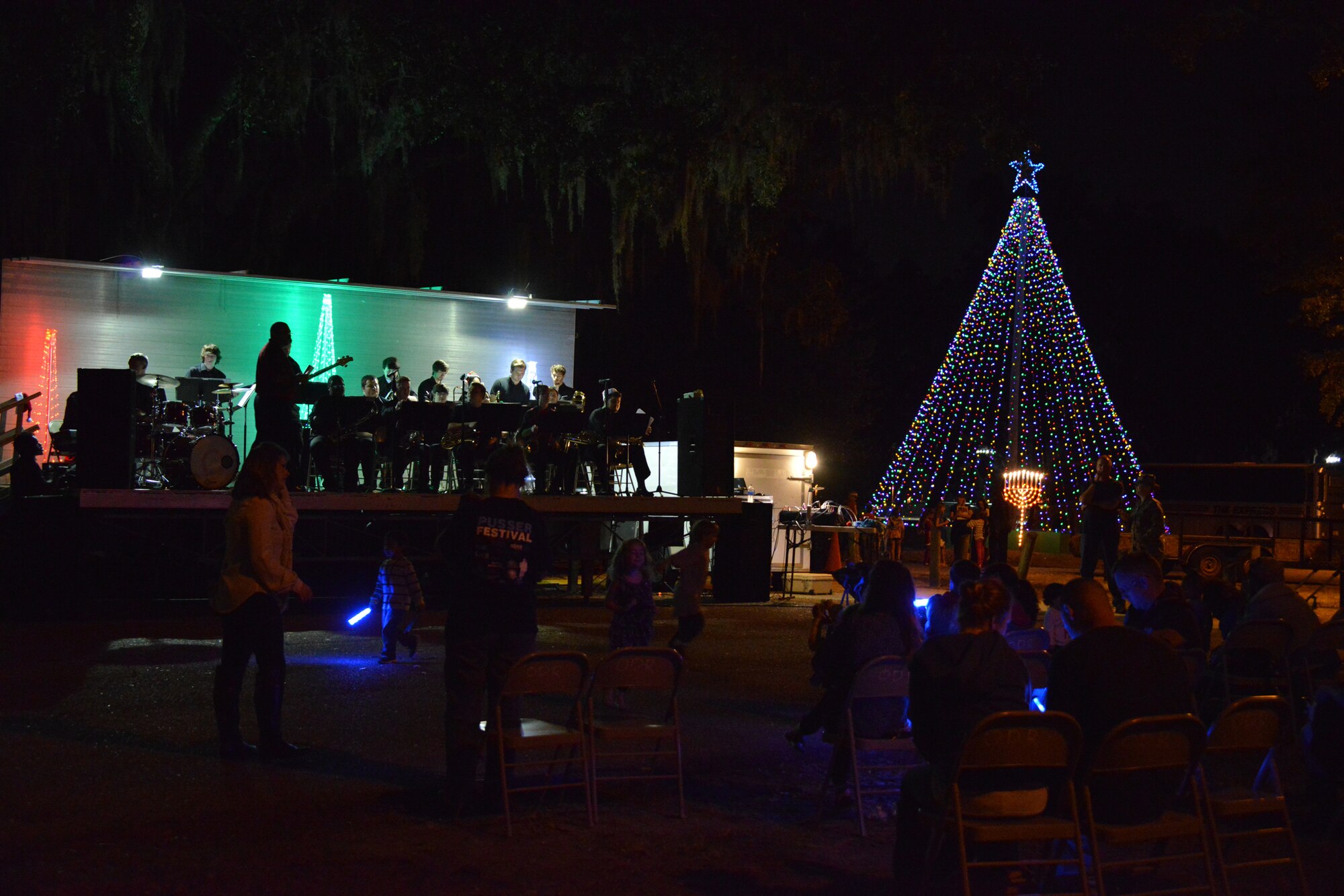 Guests at Christmas in the Park enjoy the music of the jazz band from William Carey University, after the tree lighting ceremony Dec. 3, 2014, at Marina Park, Keesler Air Force Base, Miss. The event, hosted by Outdoor Recreation, included hay rides, cookie decorating and visits with Santa. (U.S. Air Force photo by Marie Floyd)