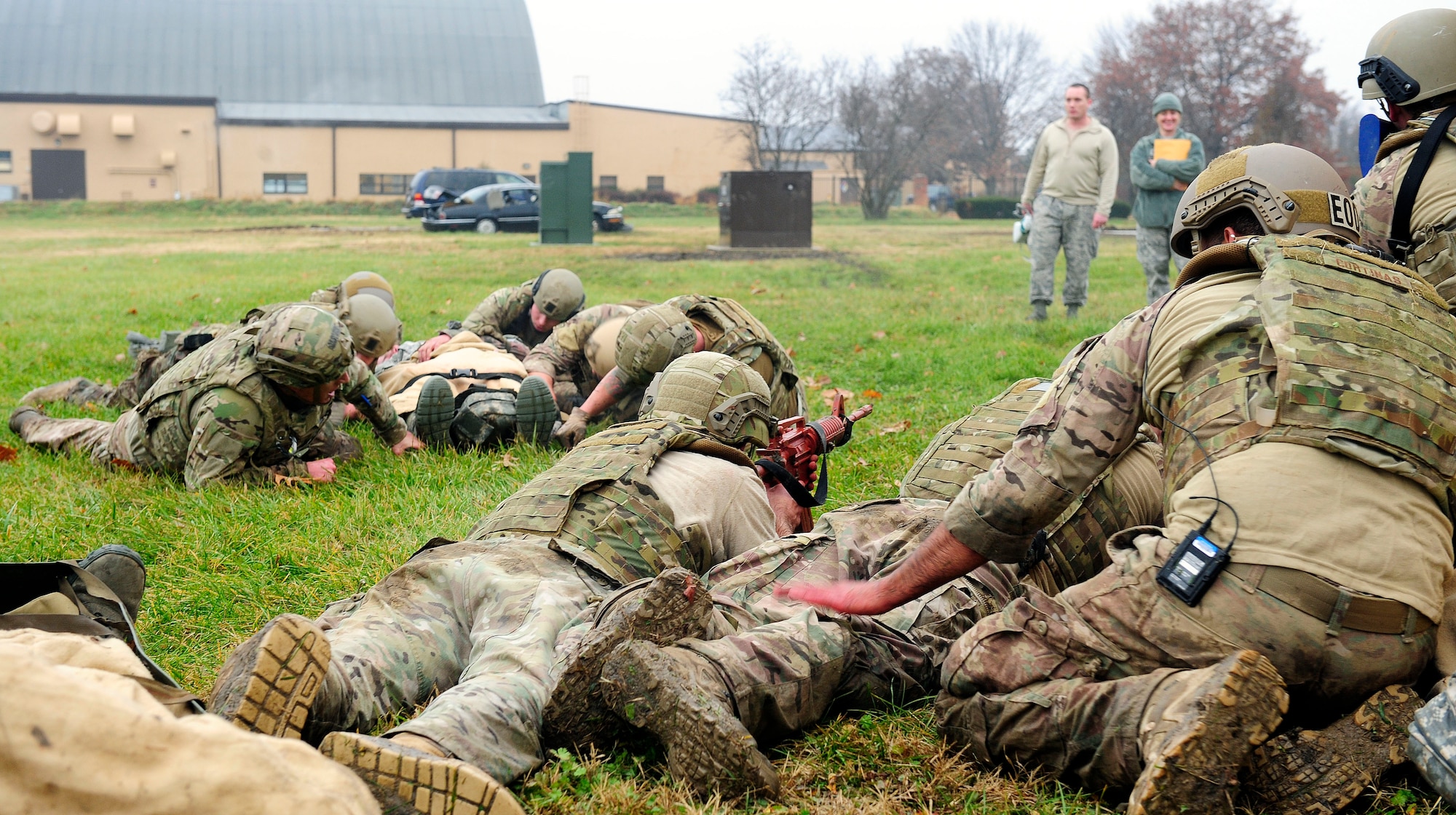 Explosive ordinance Airmen use a low crawl to transport a simulated patient out of enemy fire during a Tactical Combat Casualty Care training exercise at Scott Air Force Base, Ill., Dec. 4, 2014. The teams all made up Airmen from the 375th Air Mobility Wing and 932nd Airlift Wing Explosive Ordnance flights had four roles, a medic, medical assistant, a team leader and one security member. There are three parts to TCCC, Care under Fire, Tactical Field Care and Tactical Evacuation Care. Students are taught how to identify three major causes of potentially survivable battlefield injuries — hemorrhage, pneumothorax and blocked airway — and treat them aggressively.     (U.S. Air Force photo/ Staff Sgt. Stephenie Wade)