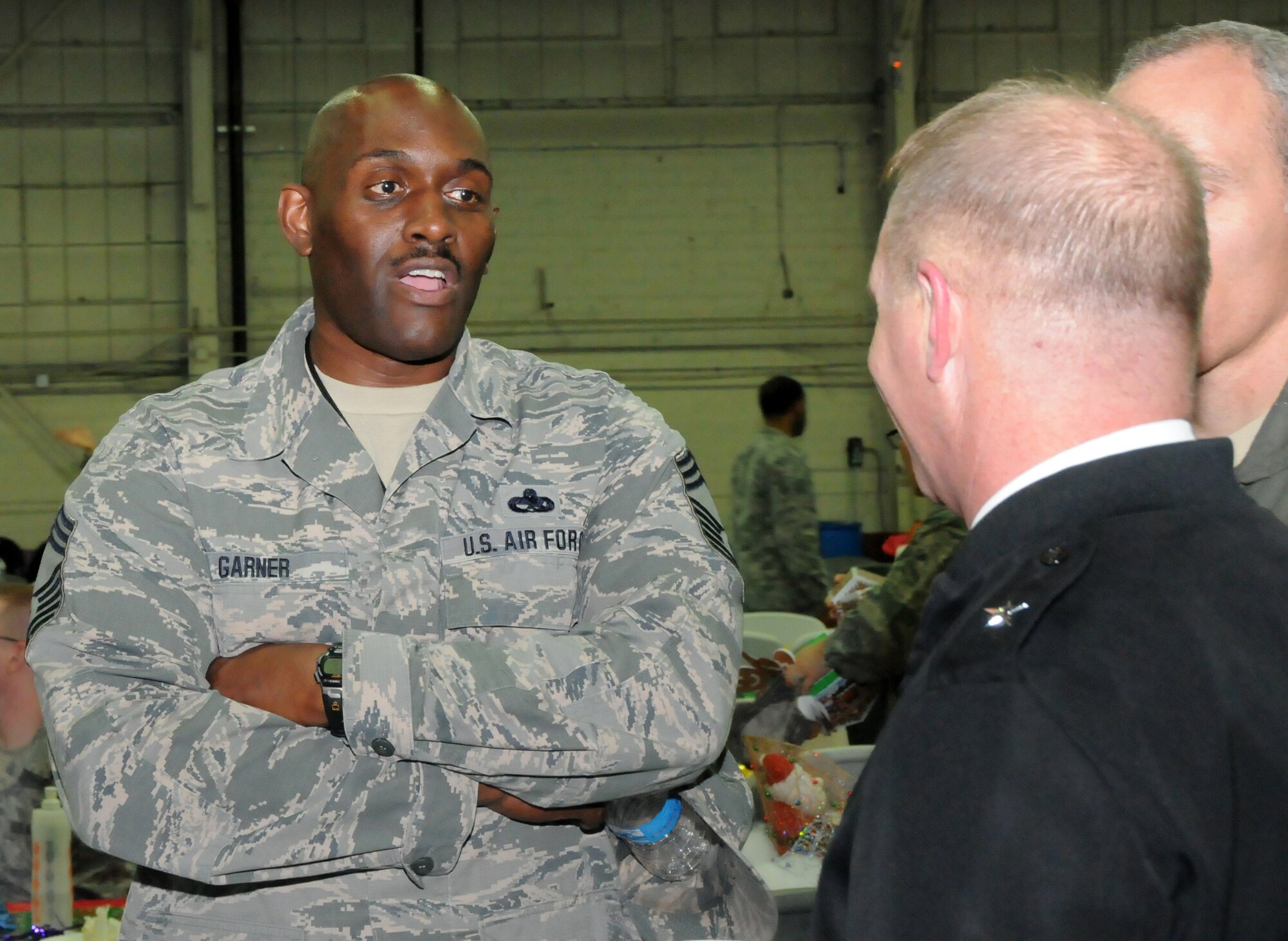 Brig. Gen. Timothy P. Williams, the Adjutant General of Virginia, talks with Chief Master Sgt. Angus Garner during the Wing’s third annual holiday celebration and awards event on December 6, 2014, at Langley Air Force Base. Williams congratulated award recipients, thanked members for their service and wished them a safe and happy holiday season.  (U.S. Air National Guard photo by Master Sgt. Carlos J. Claudio/Released)