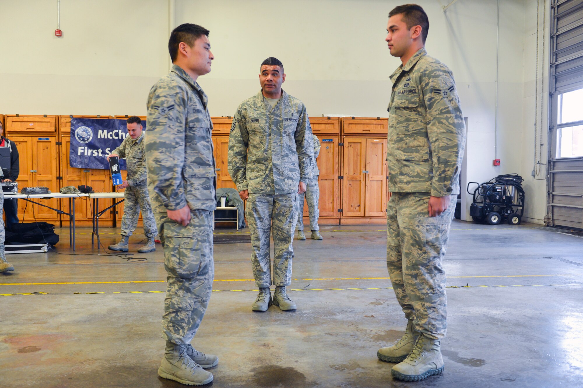 Master Sgt. Calvin Oliver, 62nd Operations Support Squadron first sergeant, turns the final two Airmen toward each other as they face off to win a PlayStation 4, Dec. 5, 2014, during Team McChord’s First Sergeant’s Council Airman’s Feast at Joint Base Lewis-McChord, Wash. Oliver gave drill commands for the Airmen to follow until the first one to make an incorrect movement was disqualified crowning the other as the grand prize winner. (U.S. Air Force photo/Staff Sgt. Russ Jackson)