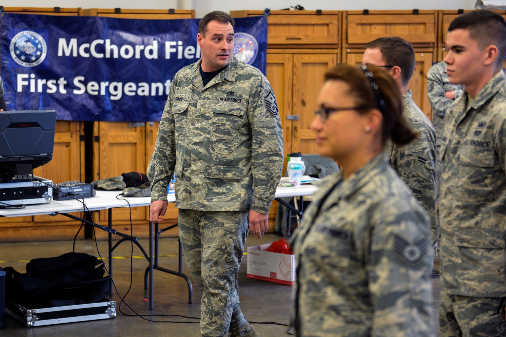 Master Sgt. Curtis Davis, 627 Logistics Readiness Squadron first sergeant, watches a group of Airmen for incorrect drill movements Dec. 5, 2014, during Team McChord’s First Sergeant’s Council Airman’s Feast at Joint Base Lewis-McChord, Wash. Davis, a former military training instructor and his fellow first sergeants from McChord’s First Sergeant Council surrounded the Airmen and pulled them out of the formation and competition for a PlayStation 4 if they were caught making incorrect drill movements. (U.S. Air Force photo/Staff Sgt. Russ Jackson)