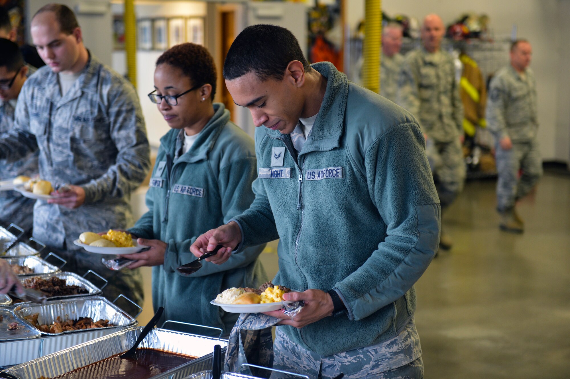 McChord Field Airmen serve themselves catered food from Dickey’s Barbecue Pit restaurant Dec. 5, 2014, during Team McChord’s First Sergeant’s Council Airman’s Feast at Joint Base Lewis-McChord, Wash. Airmen helped themselves to BBQ chicken, smoked brisket, mashed potatoes, macaroni and cheese and cornbread before the raffle for prizes began. (U.S. Air Force photo/Staff Sgt. Russ Jackson)