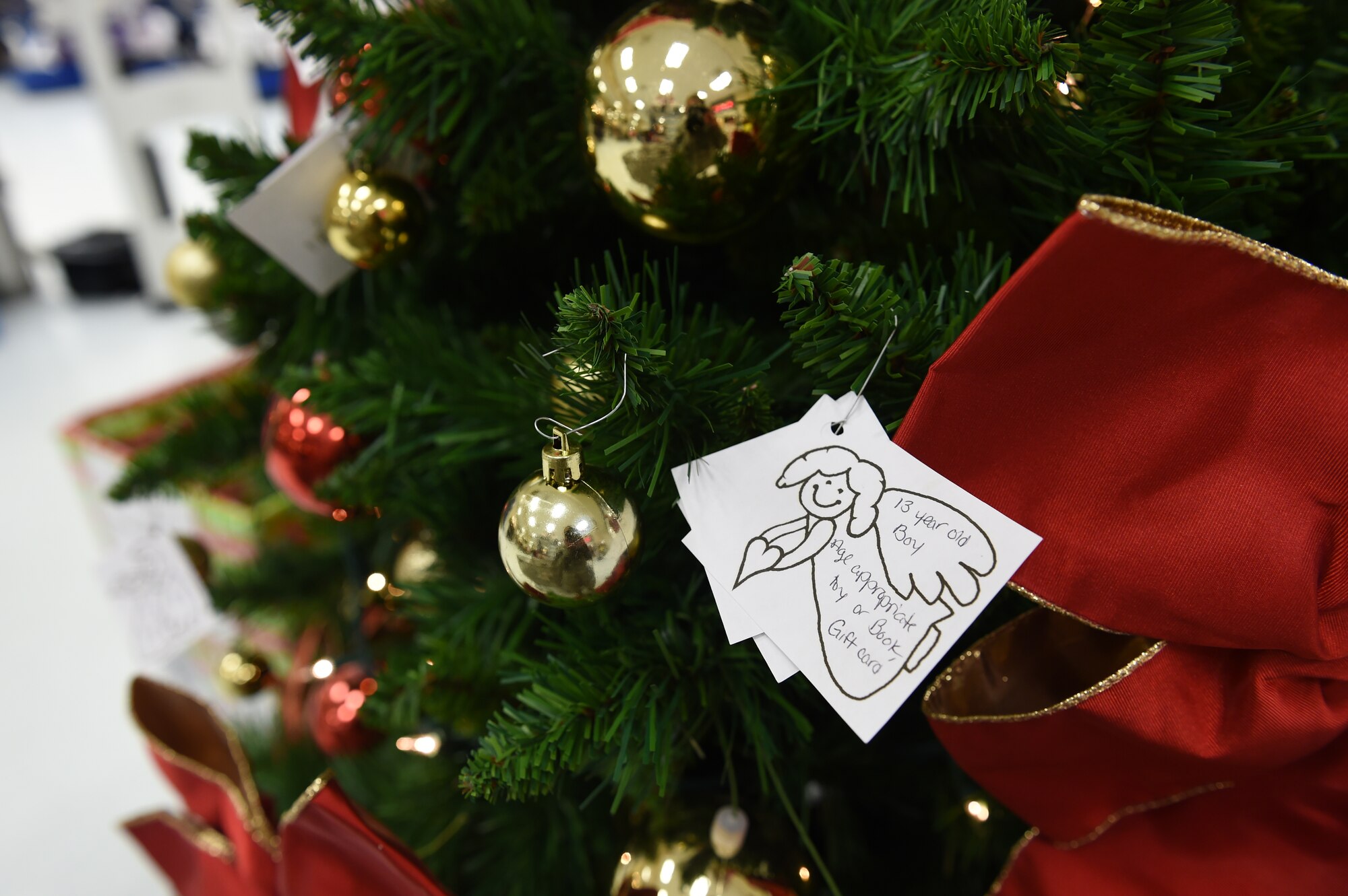 An Angel Tree has been set up at The Exchange on base for families to help those in need Dec. 3, 2014, on Buckley Air Force Base, Colo. The tree provides an opportunity to take care of Department of Defense families by purchasing gifts for children ages 17 and younger. Applications for Christmas gift assistance will be accepted through Dec. 12. (U.S. Air Force photo by Airman 1st Class Samantha Saulsbury/Released)
