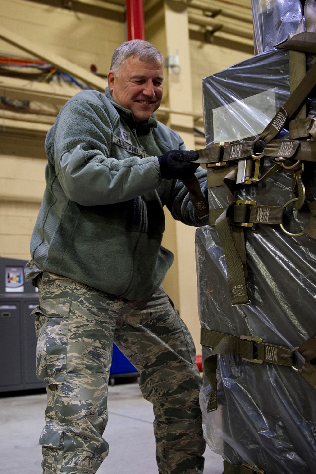 Master Sgt. James Hoagland, 434th Air Refueling Wing senior emergency actions controller, uses tie-down techniques to restrain cargo on a pallet at Grissom Air Reserve Base, Ind., Nov. 1, 2014. The techniques were taught during a pallet building course that trains Airmen on the proper ways of loading cargo onto an aircraft using a combination of geometry, algebra and tie-down techniques. (U.S. Air Force photo/Staff Sgt. Benjamin Mota)