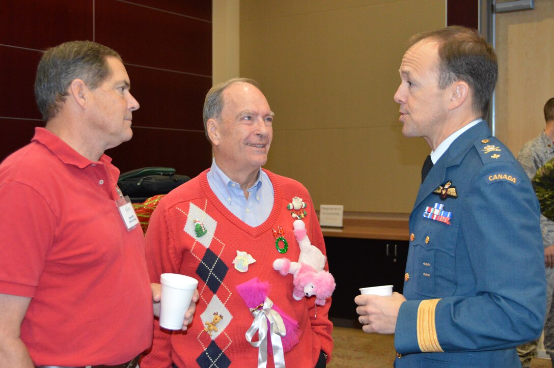 BGen Alain Pelletier, (right) Continental U.S. North American Aerospace Defense Region Deputy Commander, talks with John Griffin, (left) Air Forces Northern Chief of Staff, and Richard Musgrave, Mayor of Parker, at the Bay County Chamber of Commerce First Friday event Dec. 5. The general was at the event to present a briefing about the NORAD Tracks Santa program and the CONR mission overall. First Friday is a monthly chamber event attended by civic leaders and business owners from throughout Bay County. (Photo by Mary McHale)