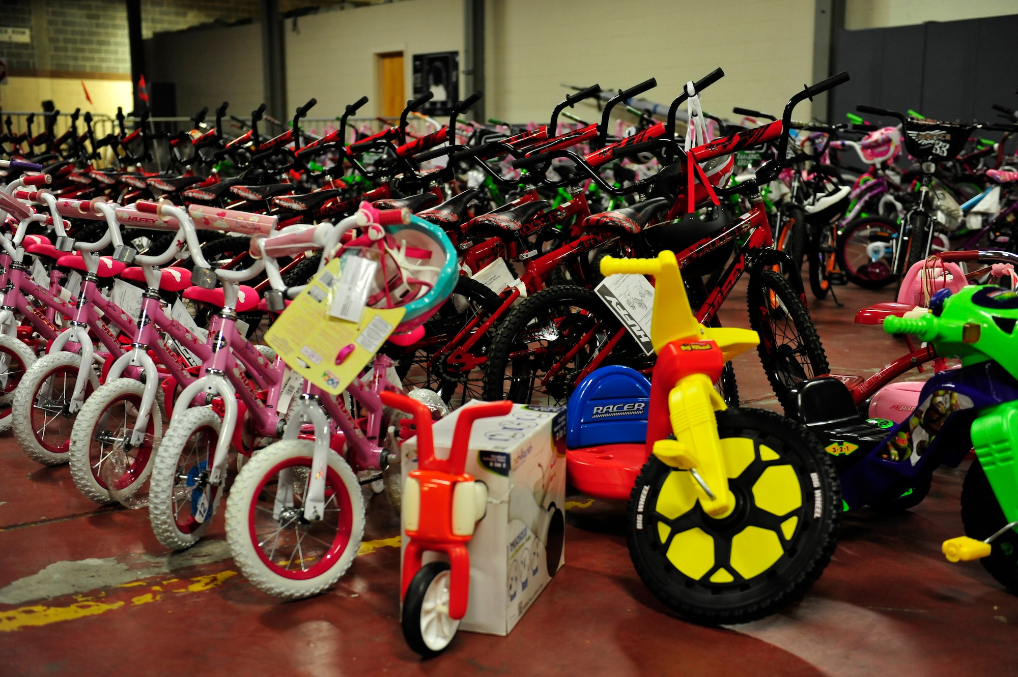 More than 120 new bikes were lined up and ready to be selected by families during the 11th annual toy distribution at Eglin Air Force Base, Fla. Dec. 5. Approximately 2,000 toys were collected by donations made throughout the year. Toys, bikes, books, games, crafts, sports equipment and stuffed animals were given to active-military families in need of assistance during the holidays. (U.S. Air Force photo/Ilka Cole)