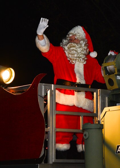 Santa Claus waves to Team Dover families as he arrives at the base housing Chapel Dec. 4, 2014, at Dover Air Force Base, Del. Santa arrived to meet with children who attended the parade and tree lighting ceremony. (U.S. Air Force photo/Airman 1st Class William Johnson)