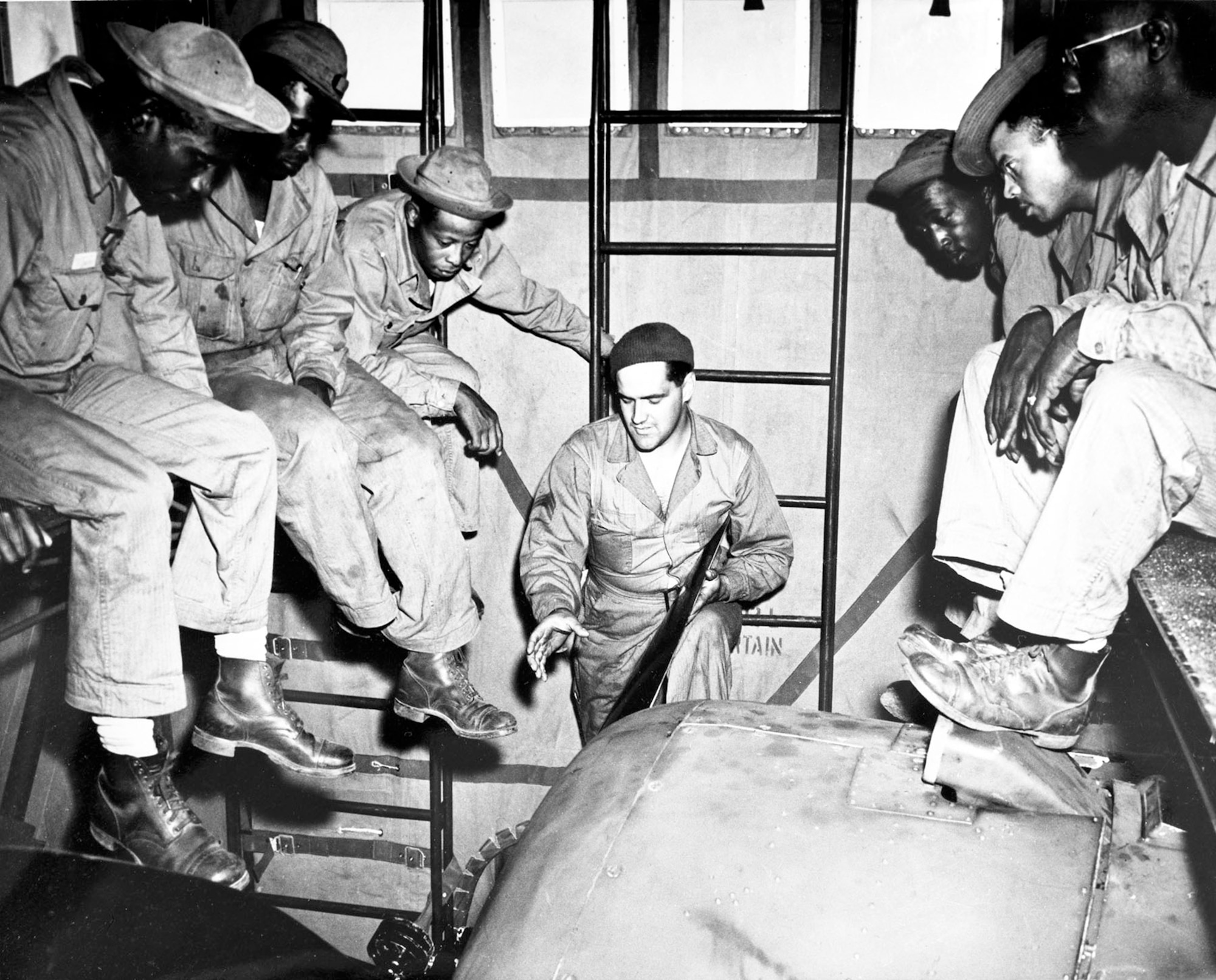 Enlisted Tuskegee Airmen receive instruction in aircraft engine maintenance at Selfridge Field, Mich. In combat, pilots depended upon the skill and training of these ground crew. (U.S. Air Force photo)