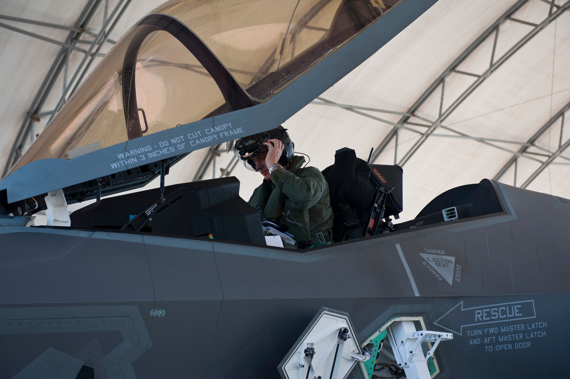 Col. Charles Wallace II, 33rd Fighter Wing F-35 Lightning II Academic Training Center director and F-35 pilot, removes his helmet after completing his first sortie in the aircraft on Eglin Air Force Base, Fla., Dec. 5, 2014. The ATC mission is to train Air Force, Marine, Navy and international partner operators and maintainers of the F-35. (U.S. Air Force photo/Staff Sgt. Marleah Robertson)